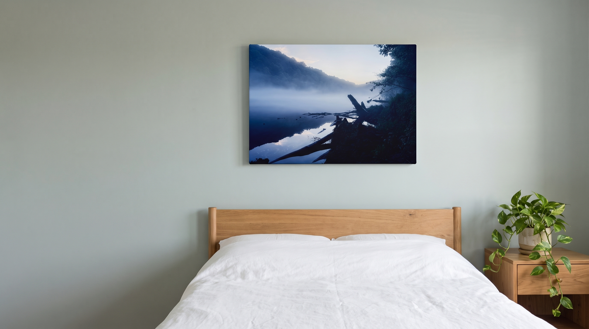 Still Water misty river canvas print above a bed in a calm sage-toned bedroom